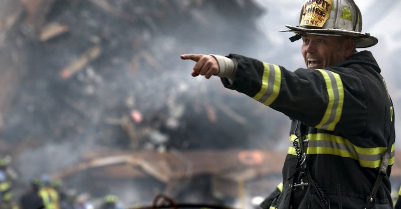 Heroes - Fire Fighter Wearing Black and Yellow Uniform Pointing for Something