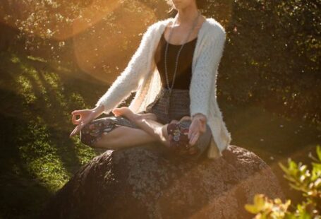 Balancing Issues - Woman Meditating on Rock