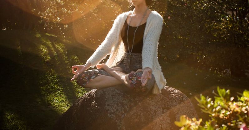 Balancing Issues - Woman Meditating on Rock